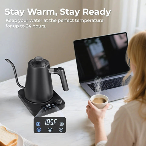 Gooseneck Electric Kettle With Precise Temperature Control Pro Grade 1L 1200W Fast Heating 24 Hour Keep Warm Auto Memory For 30 Minutes Food Grade Stainless Steel Pour Over Kettle For Coffee And Tea on kitchen counter with laptop and steaming cup of coffee.