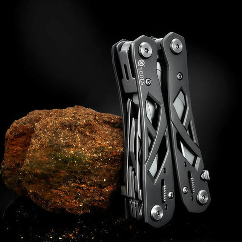 Everyday Carry 15 In 1 EDC Multitool Pliers with Spring Assisted Pliers and Safety Lock, hollow skeleton design against rock