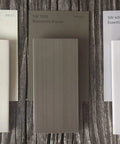 No Sweat Porch Screening System Featuring Durable Vinyl Cap And Base Rails Sold As A 20 Pack Of 1.5 By 96 Inch Continuous Rolls on a wood surface.