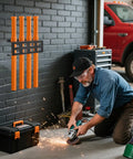 Man using angle grinder near Wall Mount Organizer With Four Tube Rod Rack for electrodes in workshop