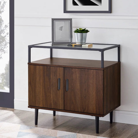 Modern wooden cabinet with black handles and glass shelf in living room.
