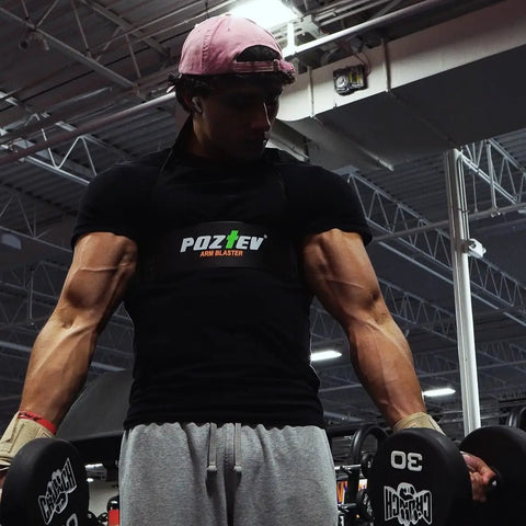 Man in gym using Arm Blaster For Biceps And Triceps Isolation Dumbbell And Barbell Curl Support To Lock Your Elbows Improve Form