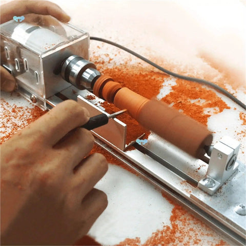 Close view of Compact Mini Lathe Machine For Metal Turning And Woodworking shaping a wood piece with orange shavings.