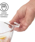 Close-up of a hand holding the large easy-grip handle on the Acrylic Oval Party Tub With Handles For Chilling Drinks Indoor Outdoor Bar Use Crystal Clear Beverage Cooler Ice Tub For Wine Beer And Soda Easy Carrying Drink Station