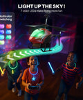 Remote Control RC Helicopter With 40 Minute Flight Time And Dual Batteries, featuring LED lights, flies above kids indoors.