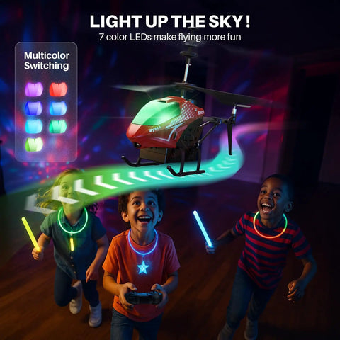 Remote Control RC Helicopter With 40 Minute Flight Time And Dual Batteries, featuring LED lights, flies above kids indoors.