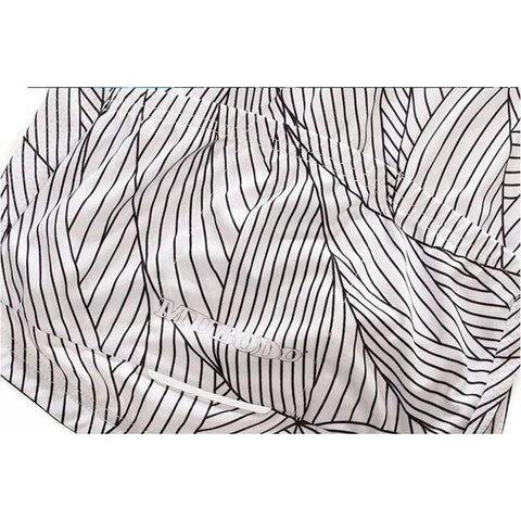 Close-up of fabric with black and white striped pattern on cloth background