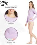 Woman wearing Womens UPF 50 Long Sleeve Rash Guard Swim Tee For Surf And Beach Peaceful Lilac Swimsuit Top with crew neck.