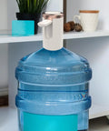 Electric Water Jug Pump For Home Office Kitchen Counter Drinking Quiet Bottle Dispenser Pump Portable Water Bottle Pump attached to a blue water jug