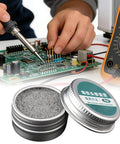 Tip Cleaner For Oxidation Removal Keeps Soldering Iron Tips Active next to circuit board and multimeter in workshop