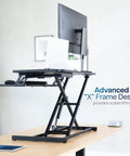 Height Adjustable 32 Inch Desk Converter With Sit To Stand Quick Elevation Tabletop Dual Monitor Riser For Home Office Ergonomic Workstation Black Go To Setup For Small Home Offices, black frame with raised platform holding a laptop and monitor.