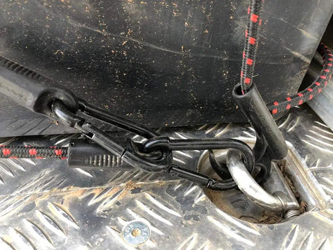 Close-up of Heavy Duty Adjustable Bungee Cords with Hook and Carabiner securing cargo on truck bed.