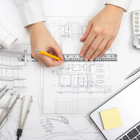 Person using the Super Handy Flexible Stainless Steel Pocket Ruler Set With Detachable Clips on architectural plans.