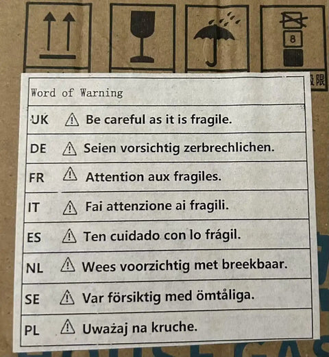 Warning label for fragile items, providing multiple language instructions for handling and care.