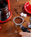 5Bar High Pressure Coffee Maker With Foam Function For Home Or Office on a wooden table, close-up view with coffee grounds.