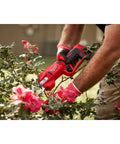 M12 Brushless Pruning Shears Cordless Power For Quick Yard Pruning in use cutting roses, lightweight ergonomic grip visible