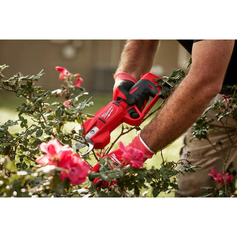 M12 Brushless Pruning Shears Cordless Power For Quick Yard Pruning in use cutting roses, lightweight ergonomic grip visible