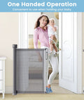 Mother holding baby using Retractable Baby Gate For Stairs And Doorways With Upgraded Double Lock 34 Inch Tall Extends Up To 72 Inch Wide Mesh Pet Gate.