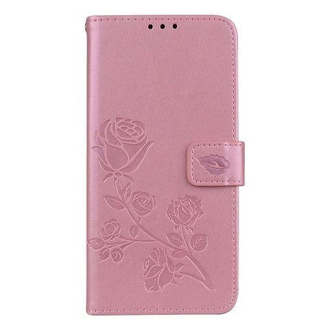 Pink leather phone case with embossed rose design and magnetic clasp.