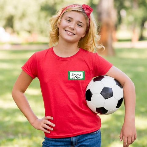 Child in red shirt holding soccer ball with 400 Soccer Name Tag Stickers Set In Green And Black With 4 Designs Adhesive Label