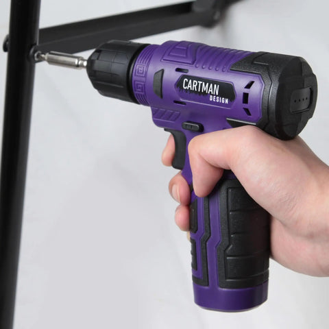 Hand using purple drill from 150 Piece Household Tool Set With 8V Cordless Drill Driver Kit For Home Maintenance DIY Projects And Repairs