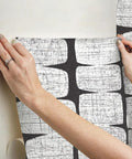 Applying Mid Century Beads Peel And Stick Wallpaper In Black And White, Self-Adhesive Removable Paper, No Mess Install on wall