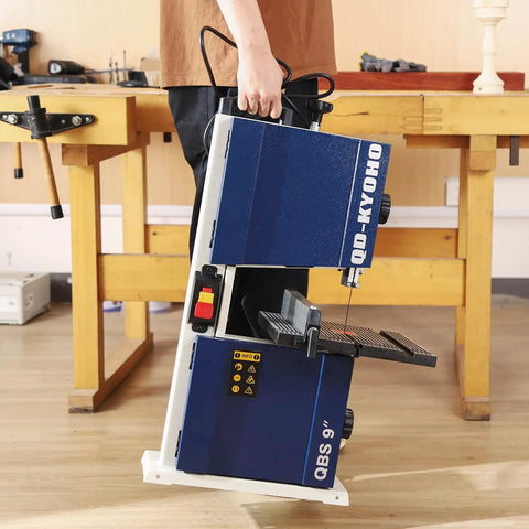 Person holding Beast Of A Portable Nine Inch Woodworking Bandsaw With Cast Aluminum Worktable And Scale, showing compact design.