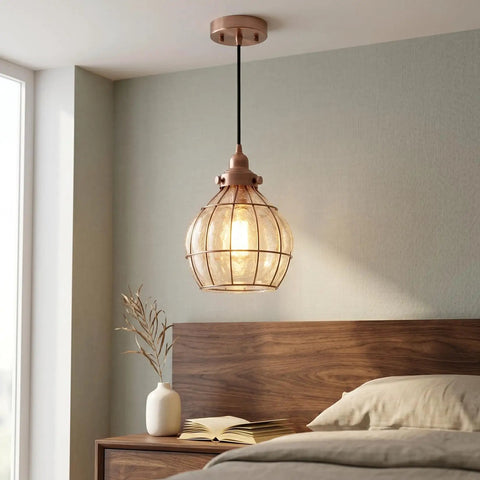 Bedroom view of Red Antique Copper Glass Pendant Light with Cracked Glass Shade over a wooden bed, displaying warm glow.