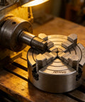 K72 125mm Four Jaw Independent Lathe Chuck Fixture With Single Movement Fast Setup Built Tough For Home Projects And Factory Machining On Metal Lathes Wide Compatibility And Secure Workholding. 125mm mangan steel chuck on lathe holding a metal shaft