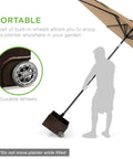 Person moving portable steel umbrella base with fillable planter, 150lb capacity, durable wheels, and handle.