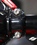 Close-up of Top Shelf Titanium Handlebar Clamp Bolts And Brake Clutch Perch Screws For Heavy Duty Motorcycles on a black fork.