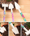 Ten Piece All In One Garden Tool Kit With Floral Print And Ergonomic Handles Including Trowel Rake Weeder Pruner Shears Sprayer And Hedge Shears In A Hard Shell Carrying Case Awesome Gift For Women And Dads, close-up of trowels and rake in floral pattern