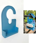 Blue 3D-printed pump holder for enteral feeding pump, shown mounted on a bike handle, with snap-fit and tubing management features.