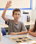 Student engaging in class with Six Dope Art Movements Poster Set For Classrooms Featuring Expressionism, Surrealism visible on desk.