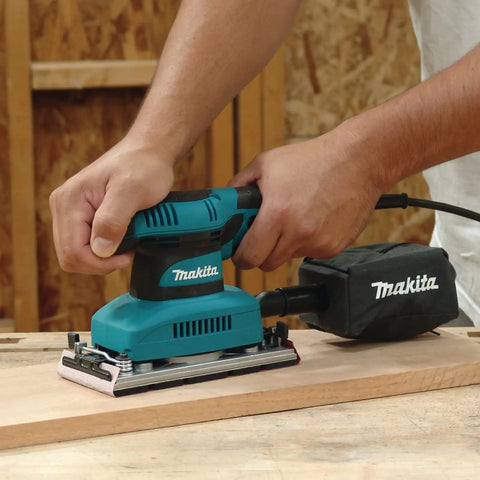 Beast Of A Sheet Finishing Sander One Third Inch Orbit, 1.7 Amp, Teal Finish With Ergonomic Rubberized Grip in use on wood