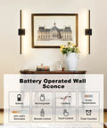 Cordless Black Rechargeable Wall Sconce With Remote 8000Mah Battery Operated Plug Free Lamp above a decorative table with flowers.