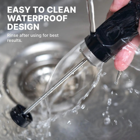 NanoFoamer V2 Milk Foamer For Home Use Microfoamed Milk In 30 Seconds With Dual Speed Waterproof Stainless Steel Build Barista Style Coffee Drinks No Fancy Espresso Rig Needed shown being rinsed under water to demonstrate its waterproof design.