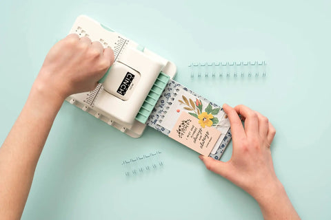 Mini Cinch Binding Tool For DIY Books And Notebooks With Wire Or Spiral Coils Pro Grade Mini Binding Machine in use on a table.