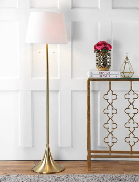 63 Inch Brass Gold Modern Glam LED Floor Lamp With White Linen Empire Shade beside a decorative console table