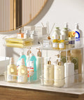 Slick Clear Under Sink Organizers And Storage Bins 2 Pack With High Low Design For Bathroom Cabinet Decluttering Pantry Organization legit space savers that slide easy, showcasing toiletries in a stylish arrangement.