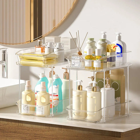 Slick Clear Under Sink Organizers And Storage Bins 2 Pack With High Low Design For Bathroom Cabinet Decluttering Pantry Organization legit space savers that slide easy, showcasing toiletries in a stylish arrangement.