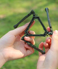 Hands holding a durable camping cookware canister stand with upgraded nylon build and nonslip base, perfect for camp trips.