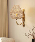 Wall-mounted natural rattan woven pendant lamp shade with hemp rope cover, emits warm ambient glow for rustic boho decor.