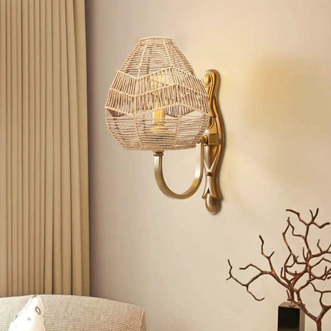 Wall-mounted natural rattan woven pendant lamp shade with hemp rope cover, emits warm ambient glow for rustic boho decor.