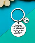 Stainless steel engineering student keychain with engraved quote and gear charm, gift for engineers and builders.