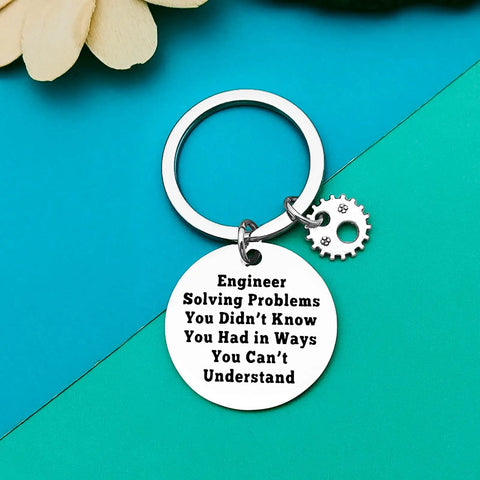 Stainless steel engineering student keychain with engraved quote and gear charm, gift for engineers and builders.
