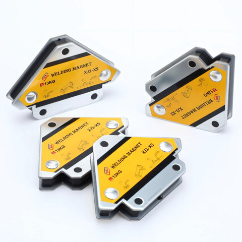 Six welding magnets with yellow labels on silver metal housings, front view for holding metal during welding.
