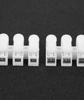 200 Pack Quick Connector Cable Clamps Terminal Block Wire Press Springs For Electric Motors And Electrical Projects, Easy 3 Step Assembly, No Drilling Required, Safe Reliable Connections showing front view of white connectors on black background
