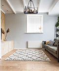 8-Light Wagon Wheel Chandelier In Black, Industrial Farmhouse Round Pendant Light in a modern living room with rug and couch.