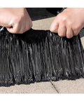 Hands holding No Sweat Heavy Duty Self Adhesive Roofing Felt Weatherproof Sealing Membrane tape, showcasing its flexible black material.
